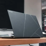 ASUS Zenbook S 14 lid opened on wooden table.