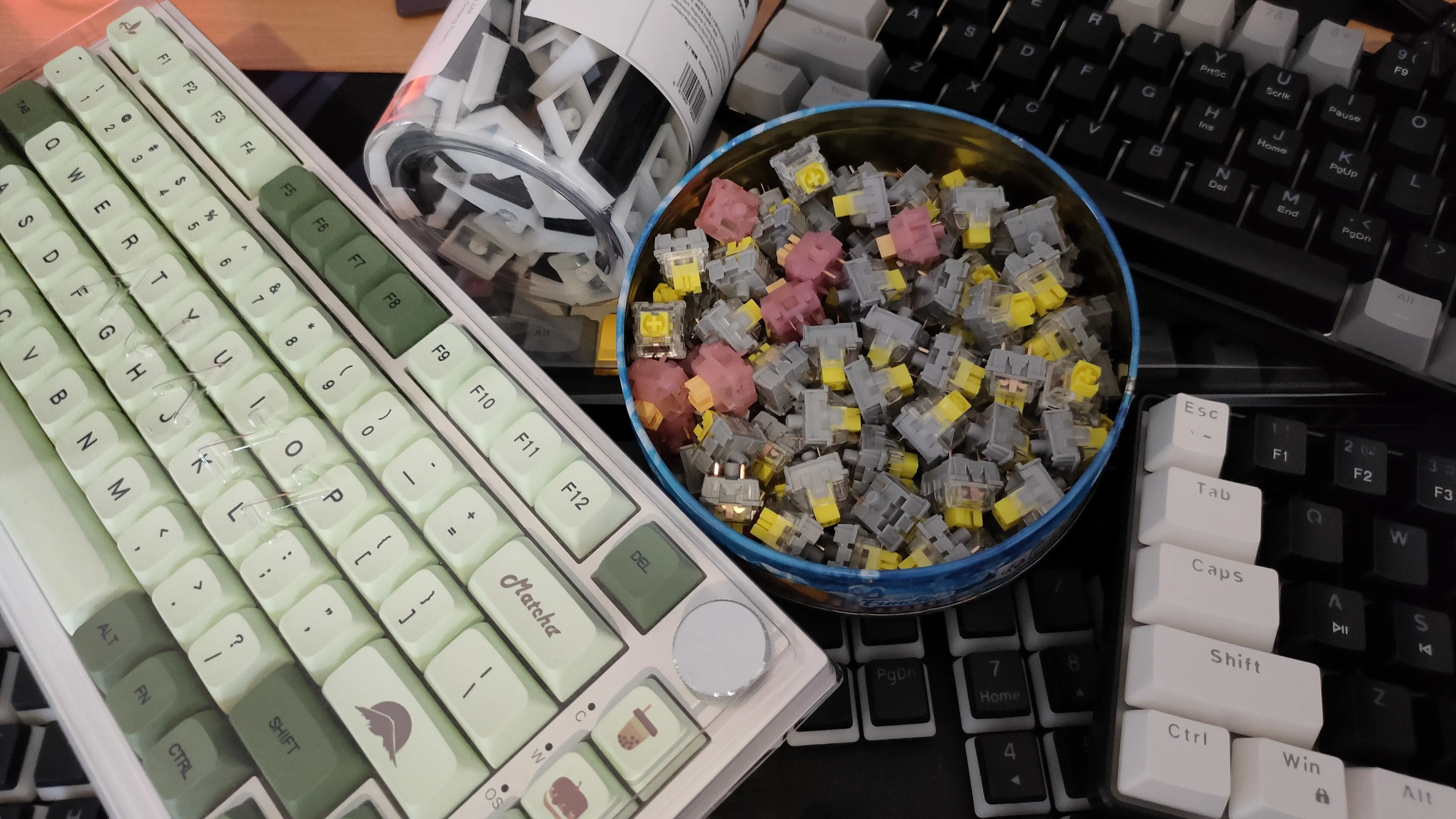 Bộ sưu tập bàn phím, switch và keycap bàn phím cơ từ Temu trên bàn, thể hiện sự đa dạng và tùy biến trong cộng đồng người dùng