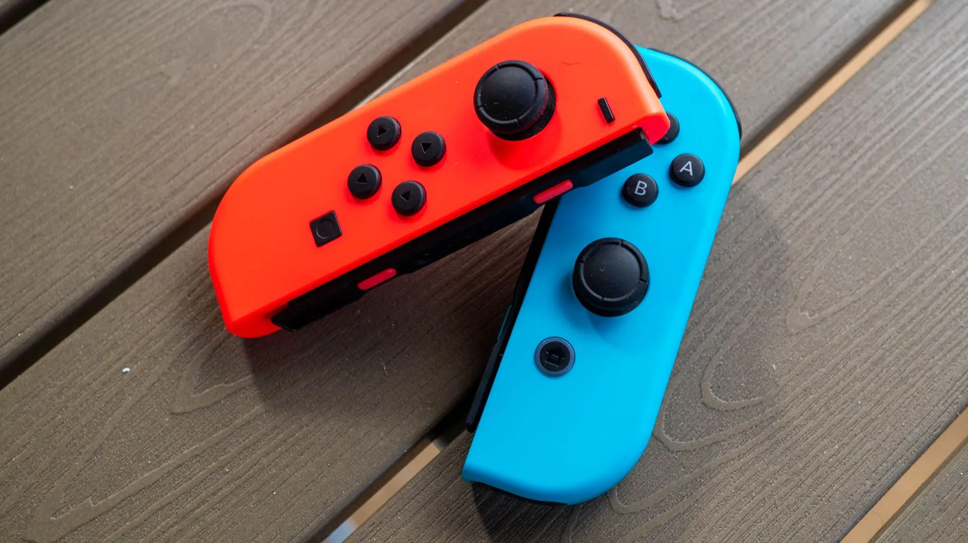 Cặp Joy-Con màu xanh và đỏ trên bàn
