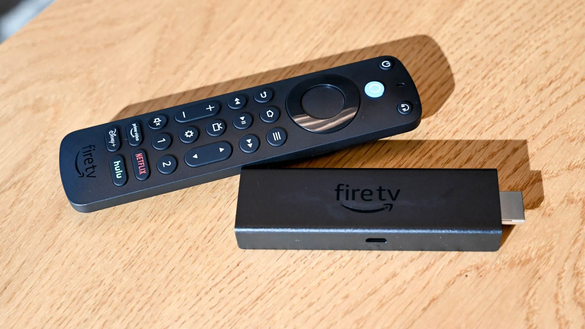 Điều khiển giọng nói Amazon Alexa Voice Remote Pro và thiết bị Amazon Fire TV Stick, đặt cạnh nhau.