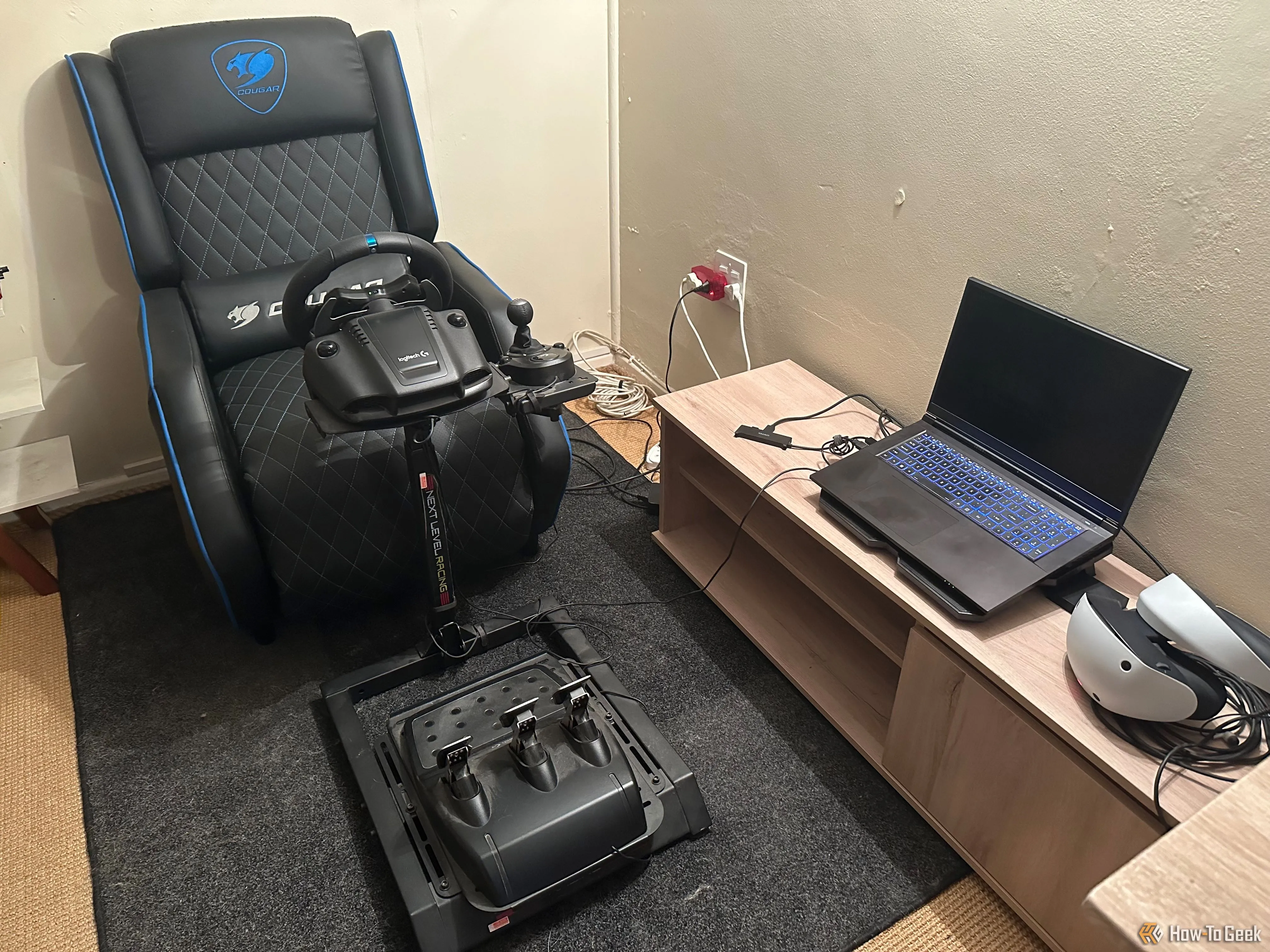 Bộ setup chơi game với vô lăng Logitech G29, laptop và kính thực tế ảo PS VR 2, cho trải nghiệm đua xe chân thực.