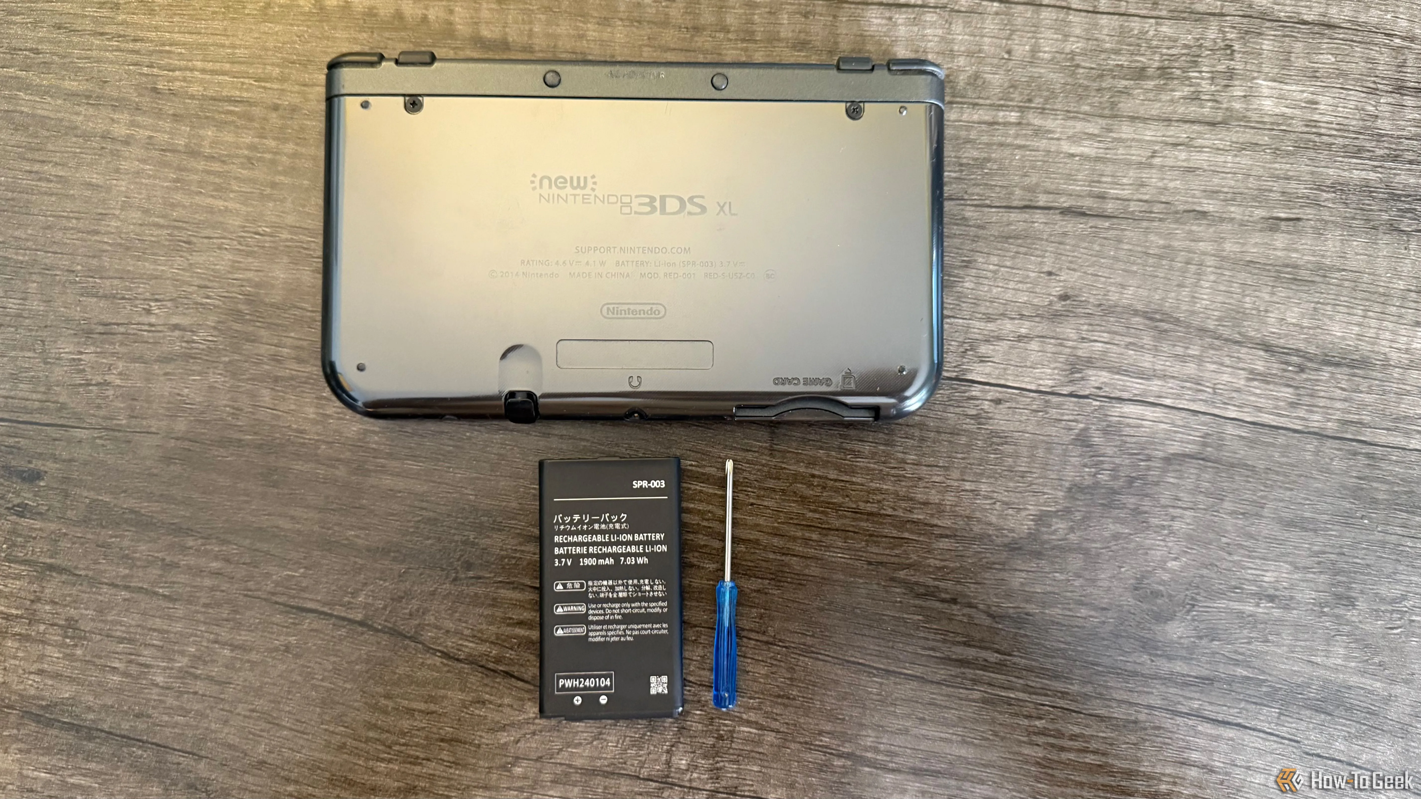 Mặt lưng New Nintendo 3DS XL cùng pin thay thế và tuốc nơ vít Phillips nhỏ
