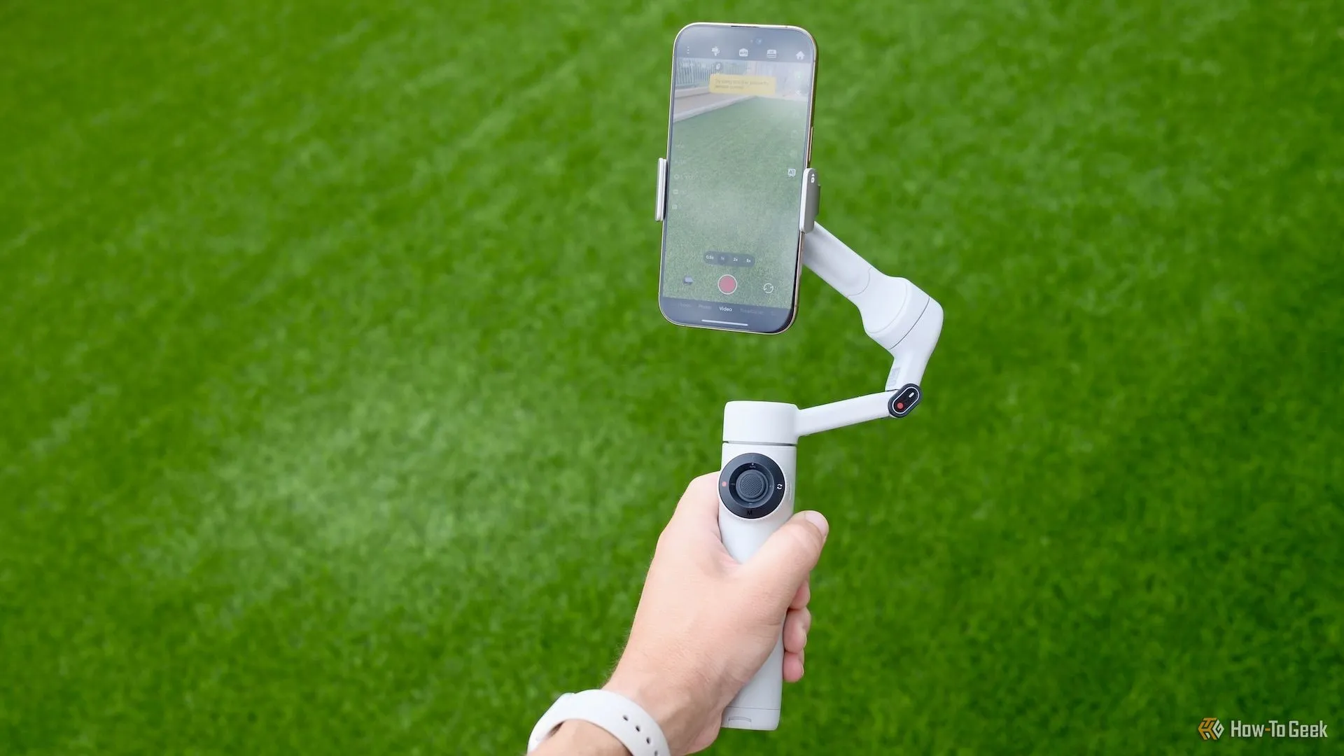 Người dùng cầm Insta360 Flow 2 đang hoạt động ngoài trời, quay video