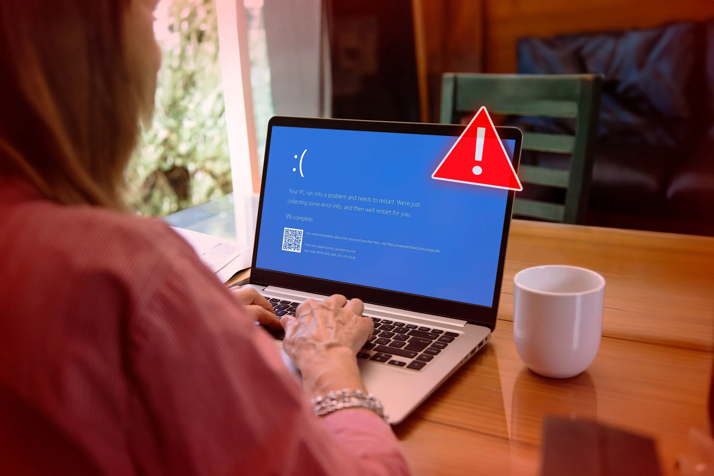 Người phụ nữ làm việc trên laptop với màn hình BSOD quen thuộc