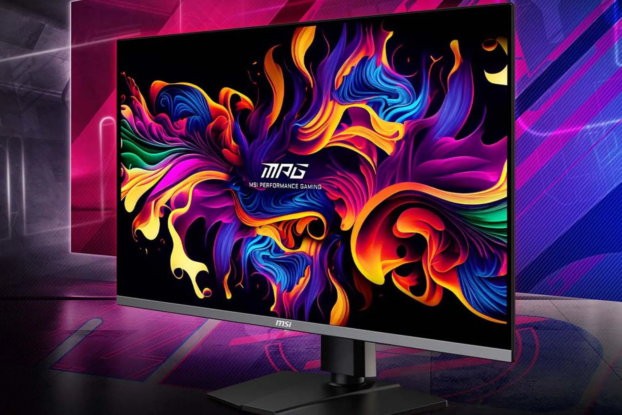 Màn hình gaming MSI MPG 321URX QD-OLED 4K đặt trên bàn làm việc với nền nhiều màu sắc