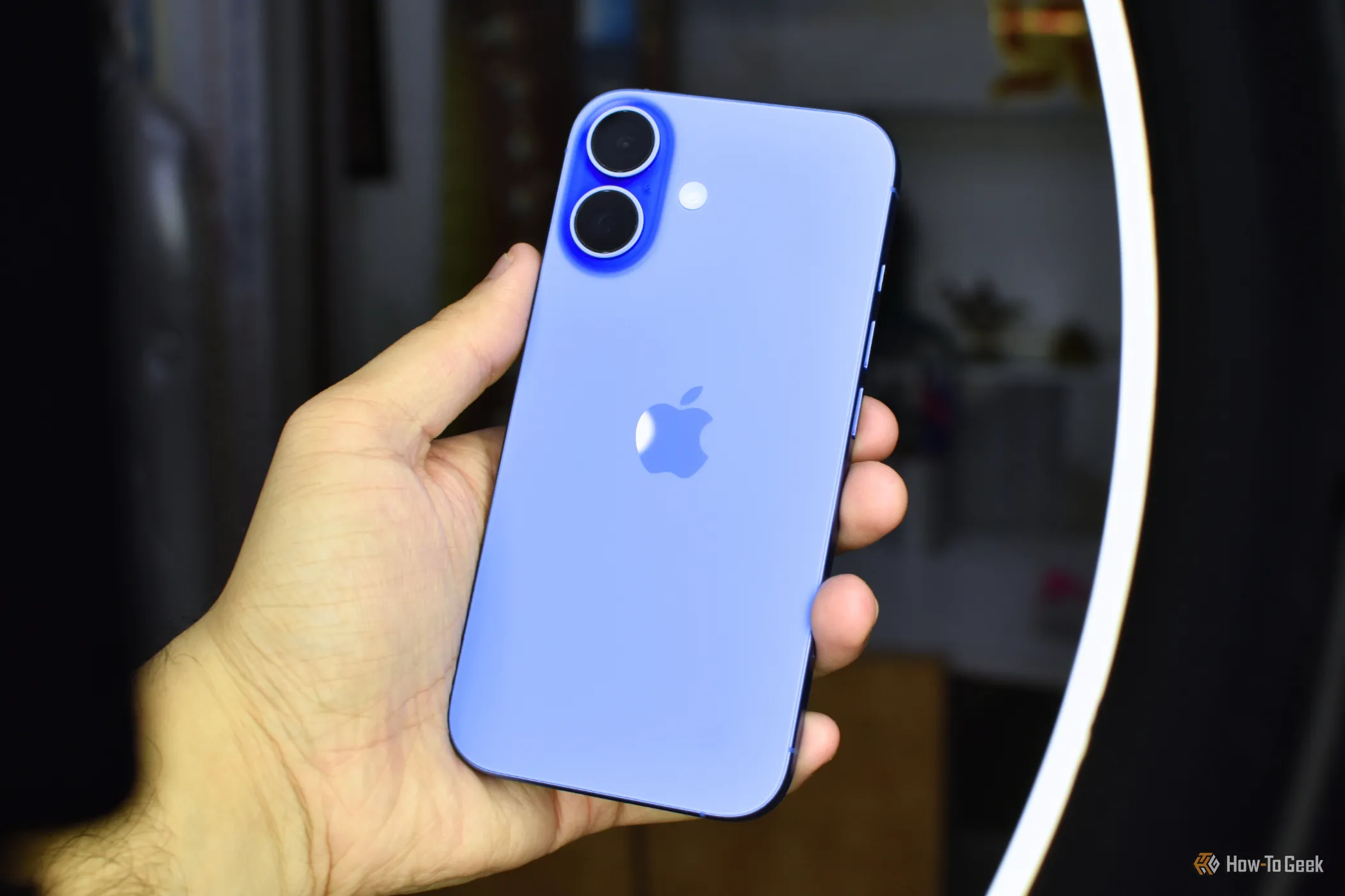Một chiếc iPhone 16 màu Ultramarine được cầm trên tay