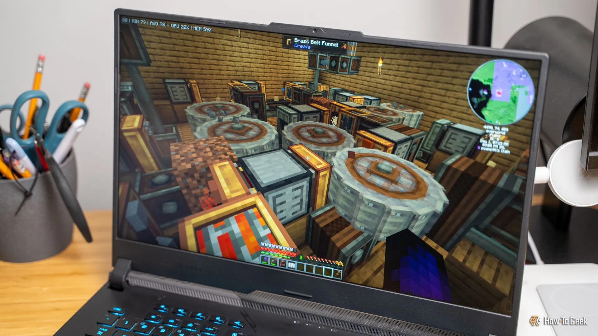 Trang trại sắt tự động được xây dựng bằng Create Mod trên laptop, minh họa khả năng tự động hóa trong Minecraft.