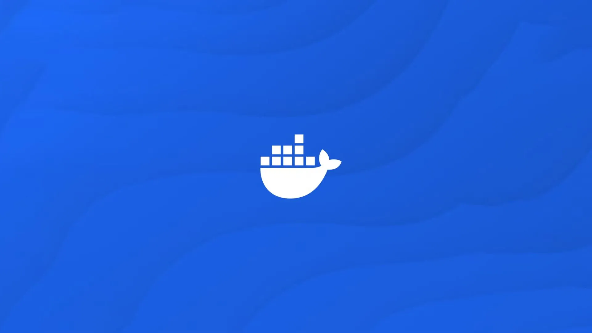 Logo Docker màu trắng trên nền xanh dương, tượng trưng cho sự mạnh mẽ và đơn giản của nền tảng container.